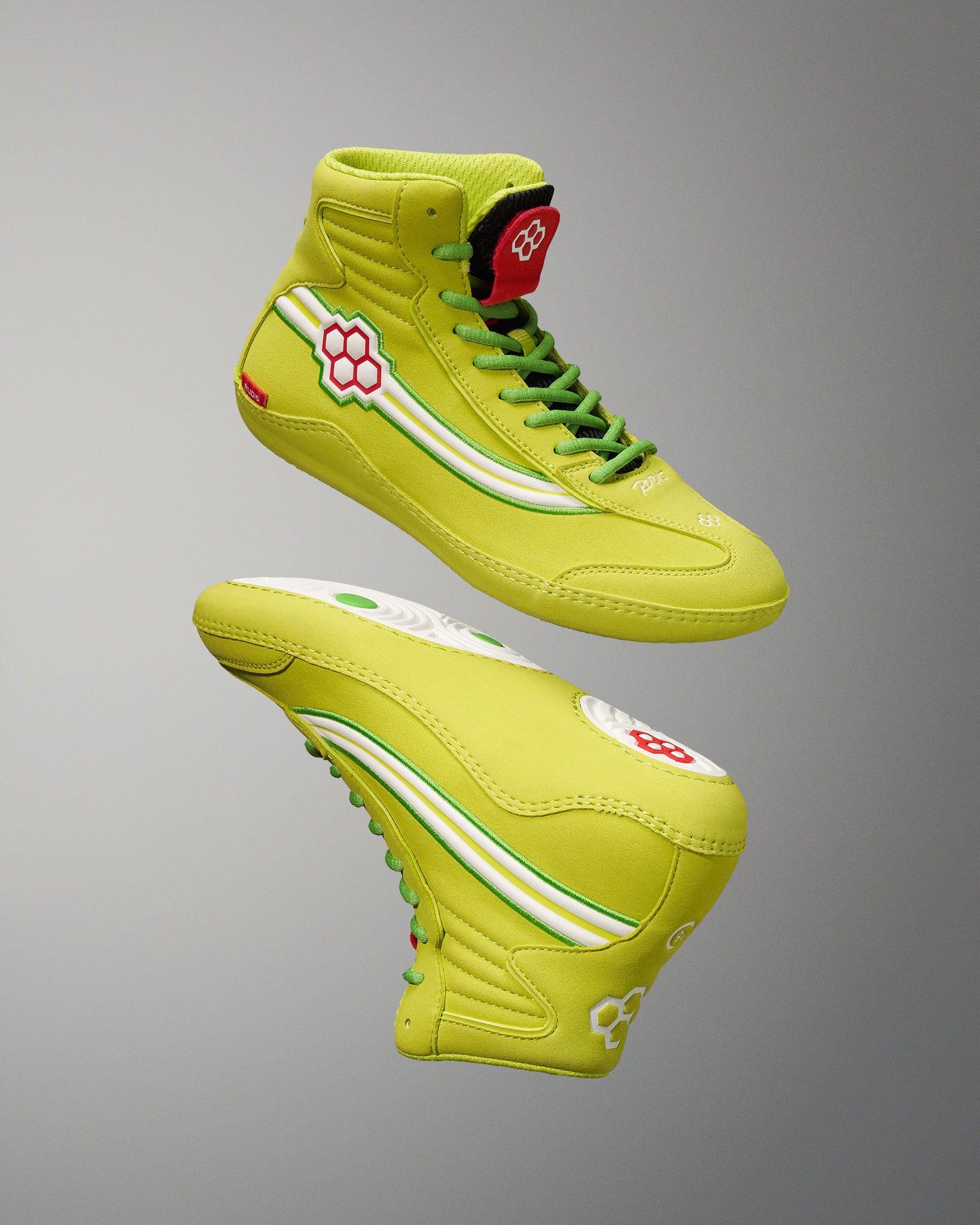 A pair of vibrant lime green high-top sneakers featuring contrasting white and red design elements highlighting playful accents and robust detailing