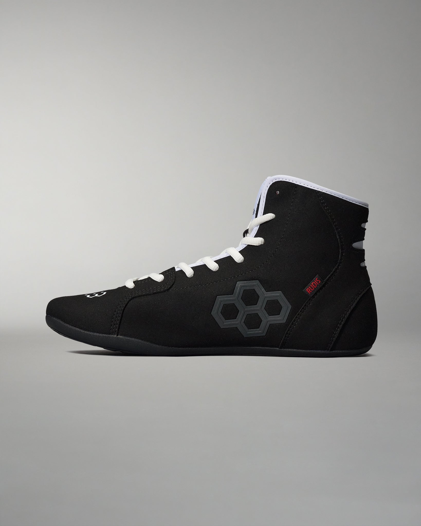 A high-top black athletic shoe with a modern design features gray accents and white laces, set against a soft gradient background.