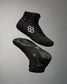 High-top black athletic shoe with textured fabric, featuring a white logo and a red 'RUDIS' tag, designed for grip and comfort against a muted gray background.