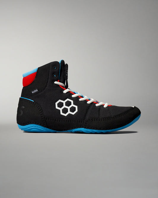 High-top athletic shoe designed for wrestling, featuring a black fabric upper with blue and red accents, a honeycomb logo, and a textured sole for enhanced traction.