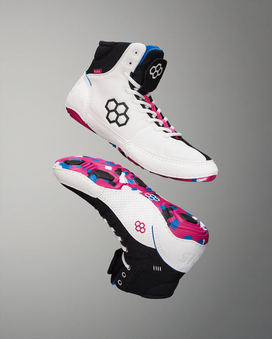 A high-top athletic shoe in white and black with colorful accents and a patterned sole, designed for sports or casual use.