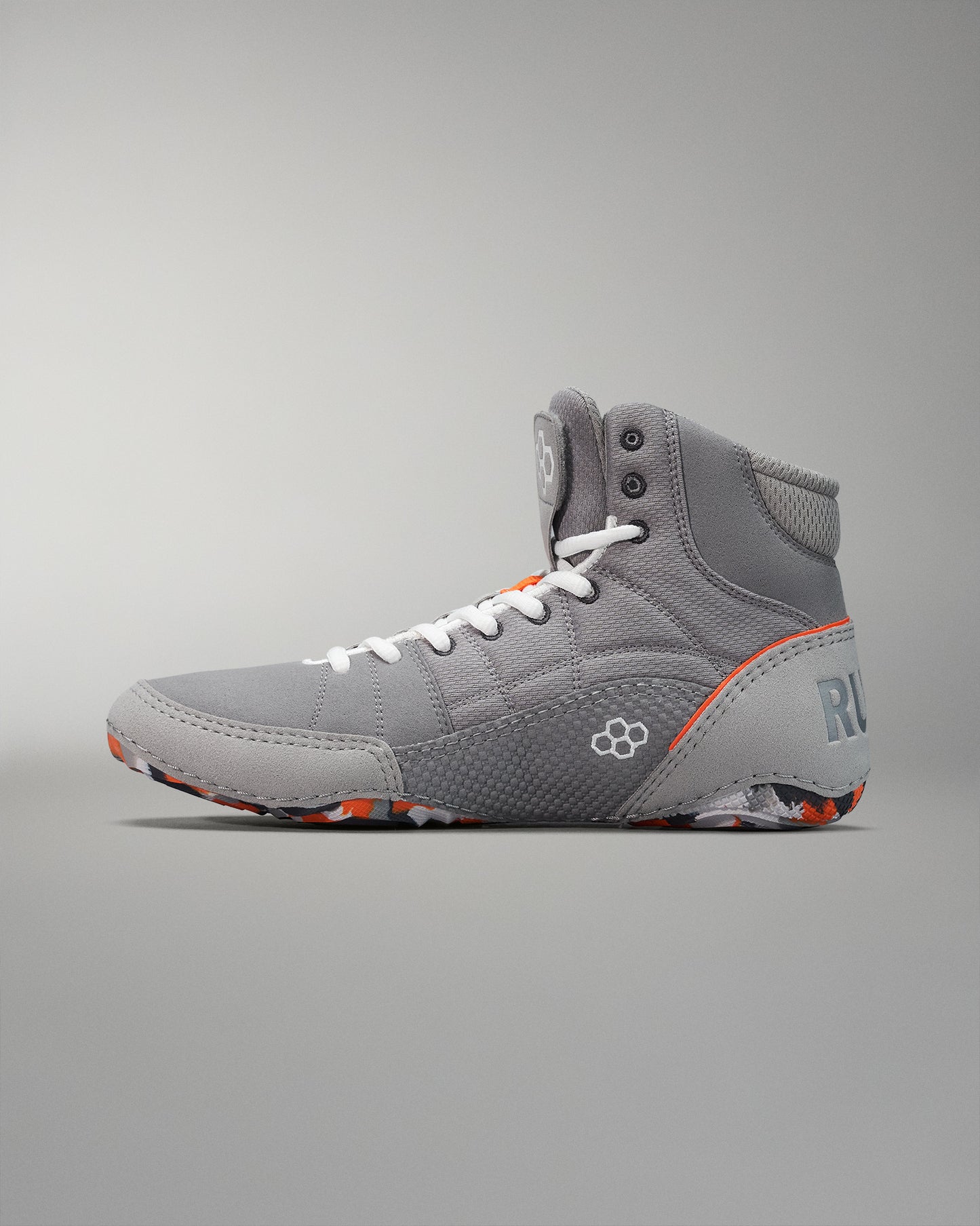 Gray high-top athletic shoe highlighted with textured fabric, orange accents, and a multi-colored patterned sole suitable for sports.