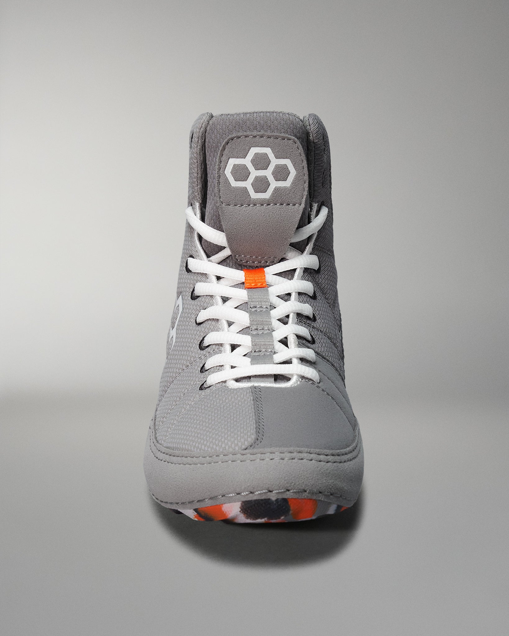 Gray high-top athletic shoe with white laces and an orange accent, designed for comfort and durability in sports or casual wear.