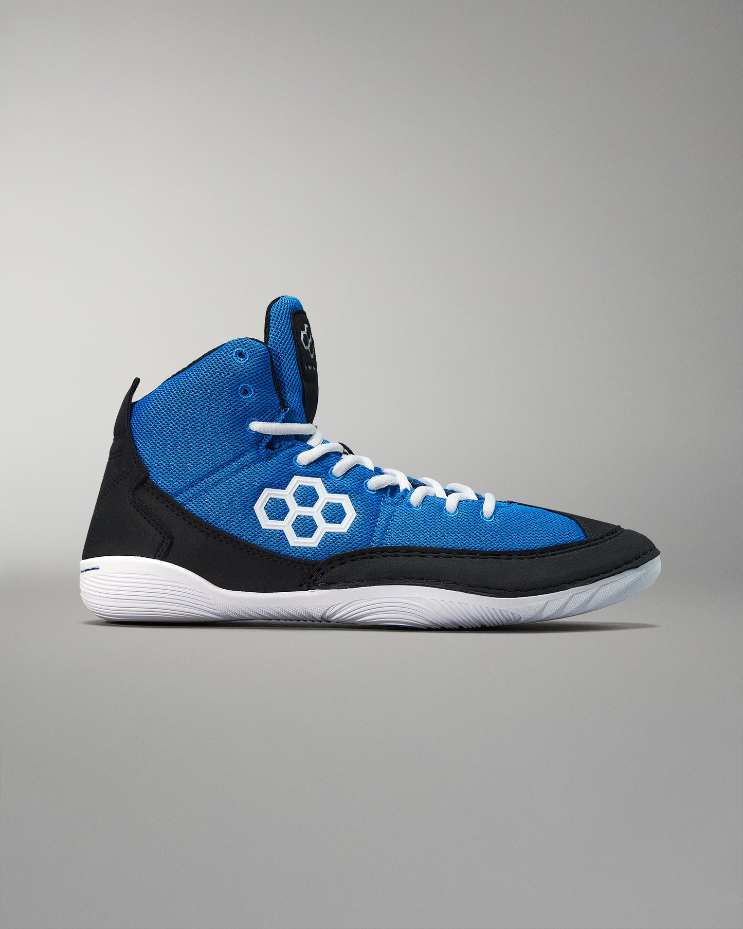 High-top athletic shoe with a vibrant blue upper and black accents, featuring white laces and a hexagonal logo, set against a soft gray background.