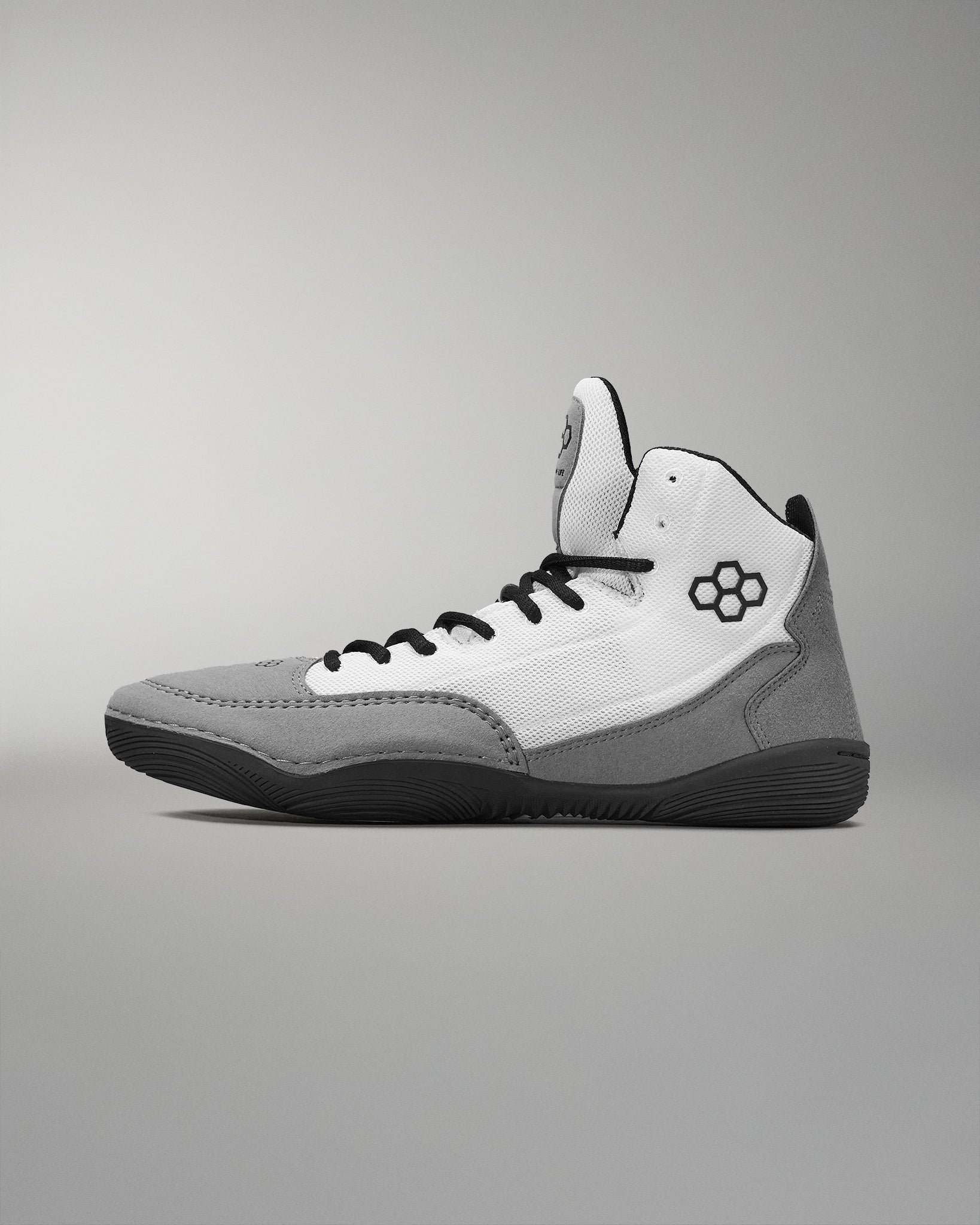 High-top athletic shoe with a gray and white upper, black accents, and a textured rubber sole for grip.