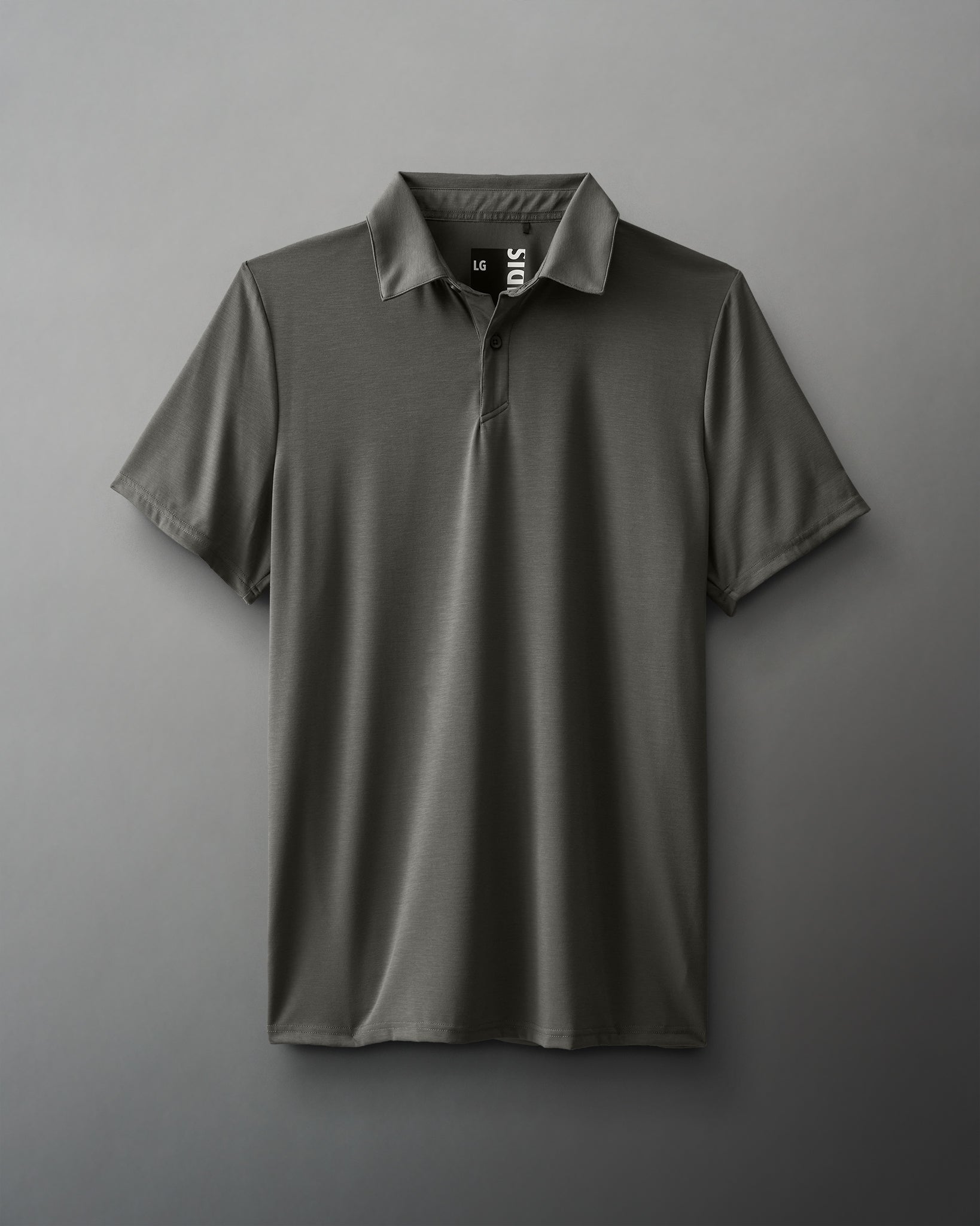 A dark green polo shirt with short sleeves and a classic collar is flat against a muted gray background, highlighting its casual elegance and versatility.