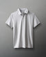 A plain white polo shirt with a classic design and three-button placket is showcased on a smooth gray background, emphasizing its versatility for casual or semi-formal wear.