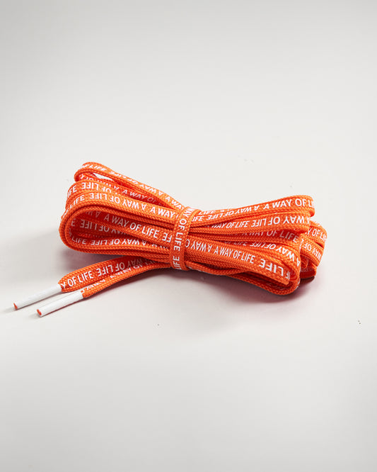 Bright orange shoelaces featuring a repeated text pattern that reads A WAY OF LIFE