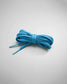 A neatly tied bundle of bright blue shoelaces resting on a gray background showcasing their textured fabric and smooth tips