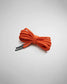 A vibrant orange shoelace tied neatly showcasing its textured fabric and aglet ends with branding