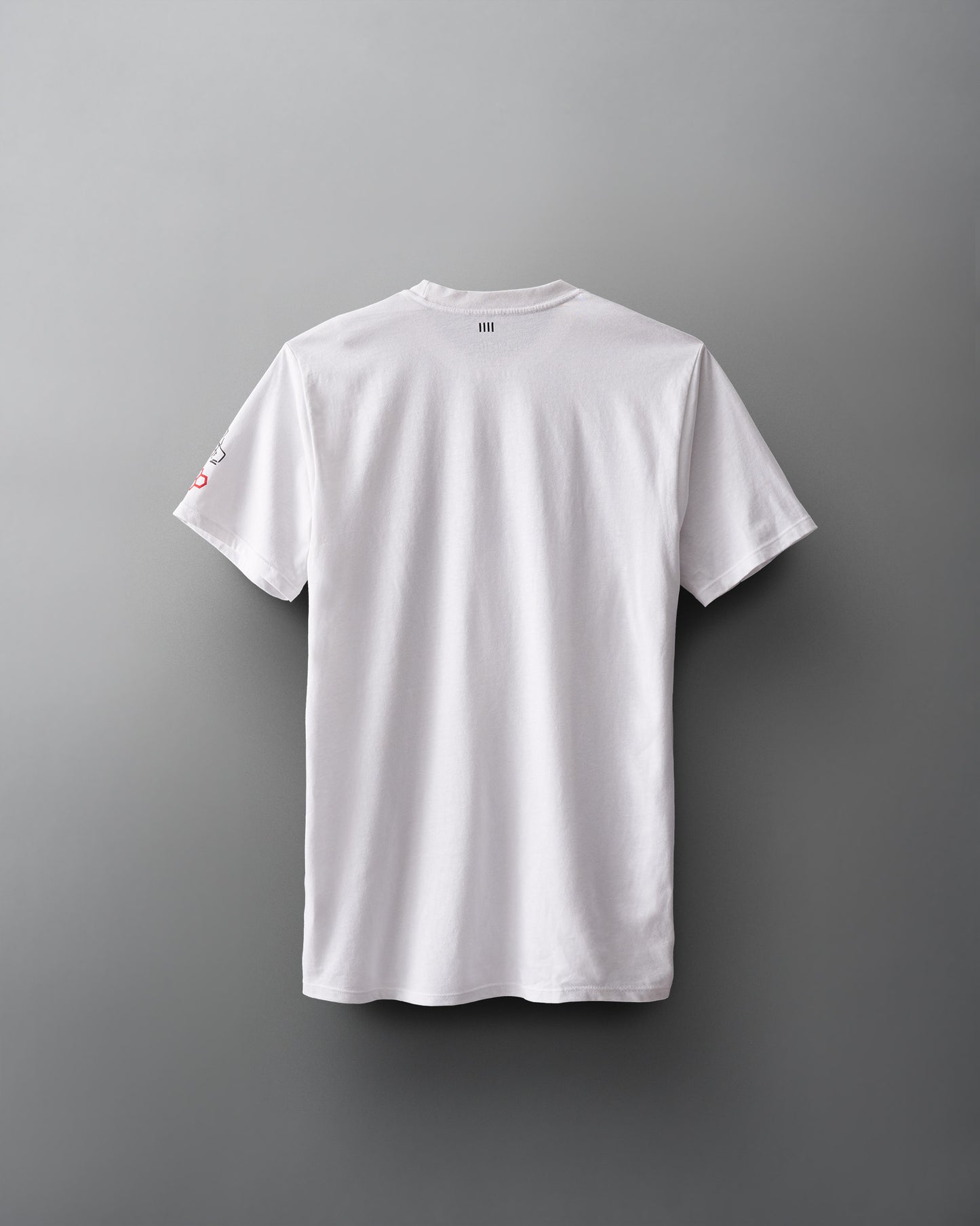 A plain white t-shirt hangs against a soft gray background, showcasing its back view with a smooth, unadorned fabric and no visible logos.