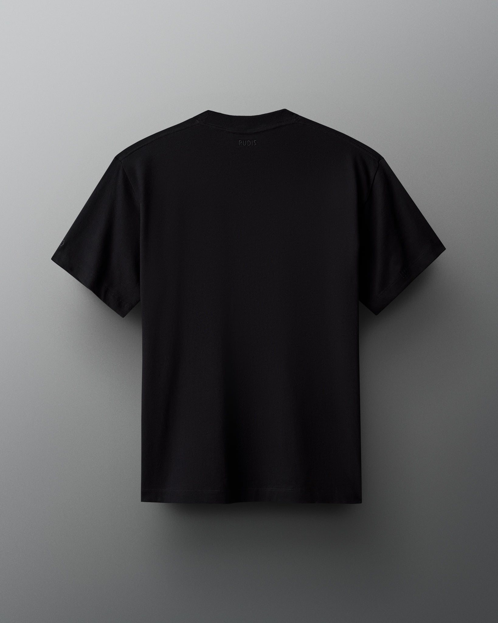 A minimalistic black t-shirt is shown from the back, featuring the 'RUDIS' label at the collar, against a contrasting gradient gray background.