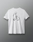 A white t-shirt features a minimalist black line drawing of a sitting figure, complemented by a small graphic on the left sleeve against a gray background.