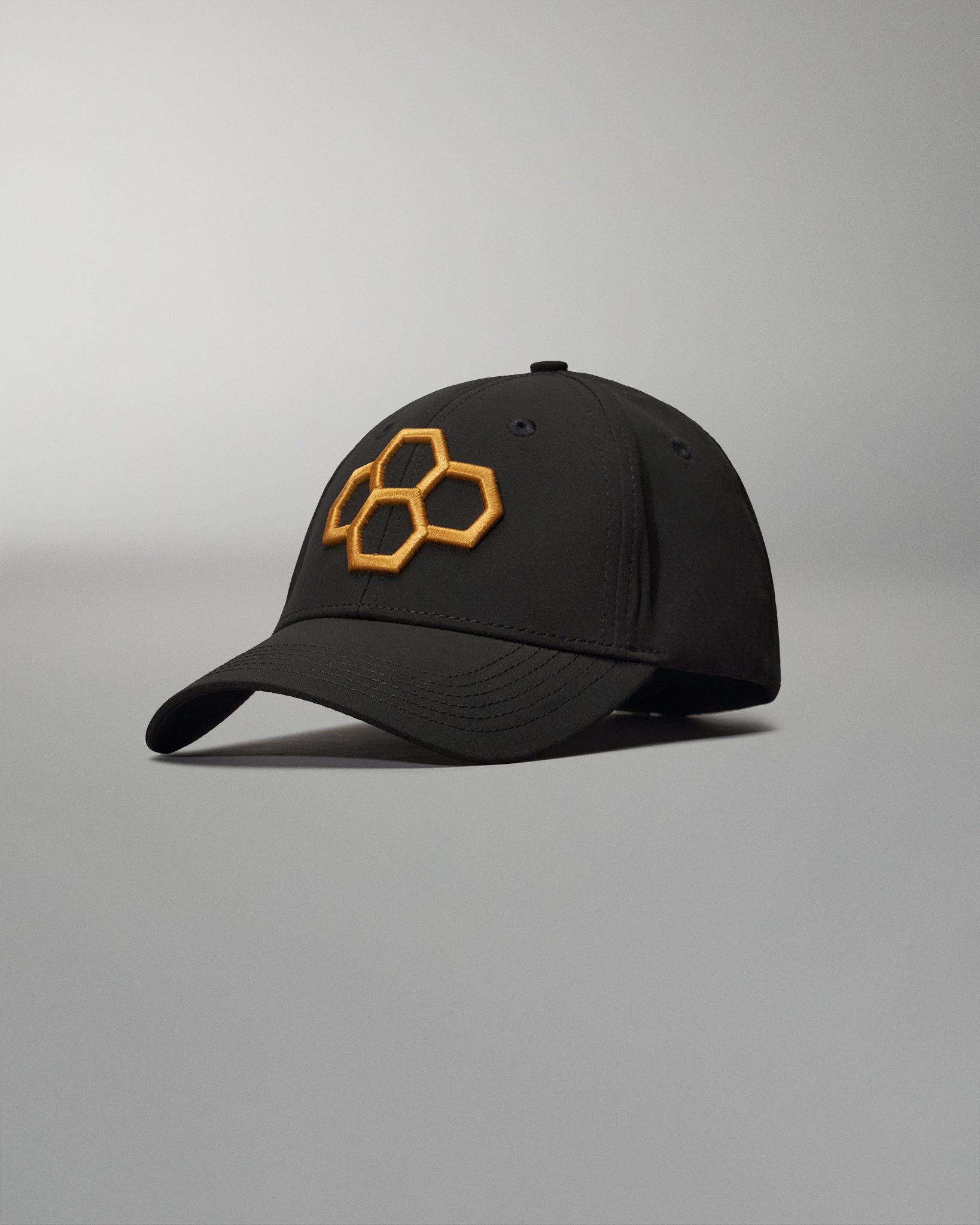 A sleek black cap featuring a prominent orange hexagonal logo on the front perfect for casual or active wear