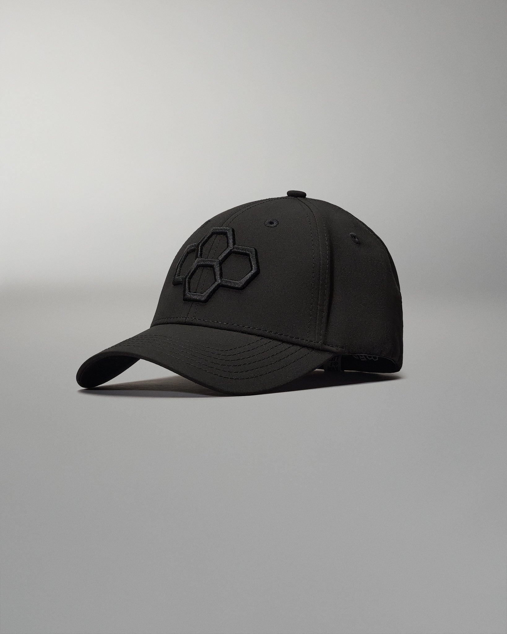 A sleek black cap featuring a raised honeycomb logo on the front perfect for casual wear and outdoor activities