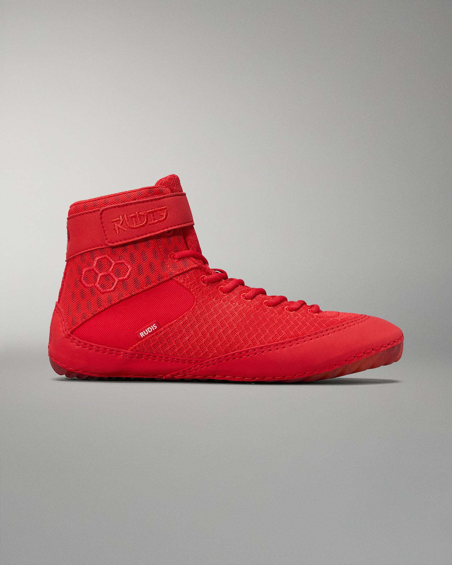 High-top wrestling shoe in vibrant red, showcasing a breathable mesh upper and secure fit features for performance.