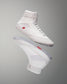 High-top athletic shoe in an all-white design with red and gray accents, featuring a textured upper and padded collar for support and comfort.