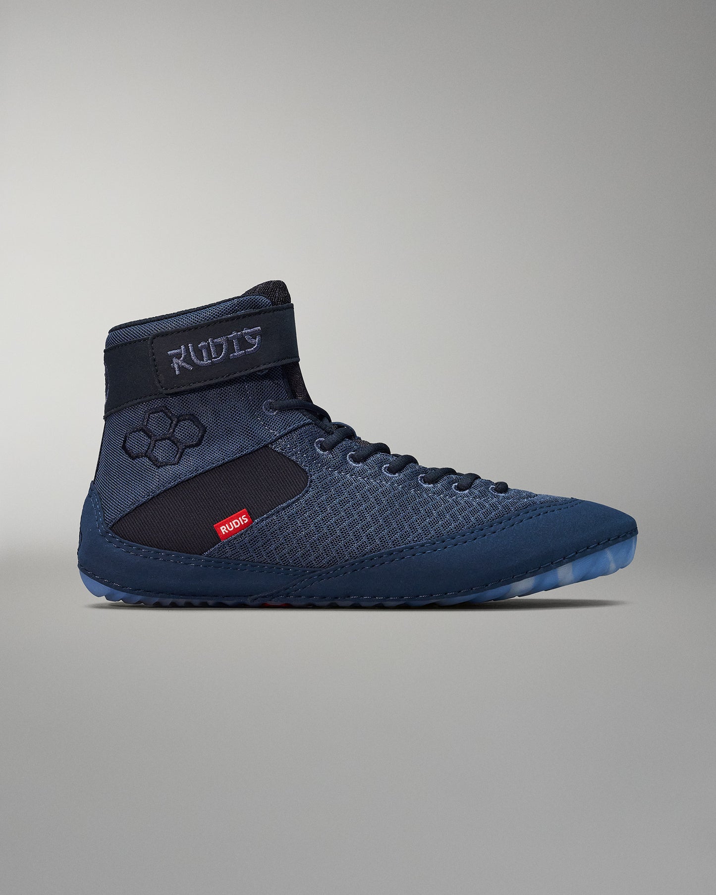 High-top athletic shoe with a blue textured upper and black side panel, featuring a supportive ankle strap and a translucent sole against a soft gray background.