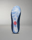 The sole of a shoe showcases a fluid blue design for grip, accented by a red logo, amidst a dark blue upper, all set against a soft gray background.