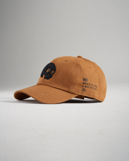 A stylish brown baseball cap featuring an embroidered logo and the phrase WRESTLING A WAY OF LIFE