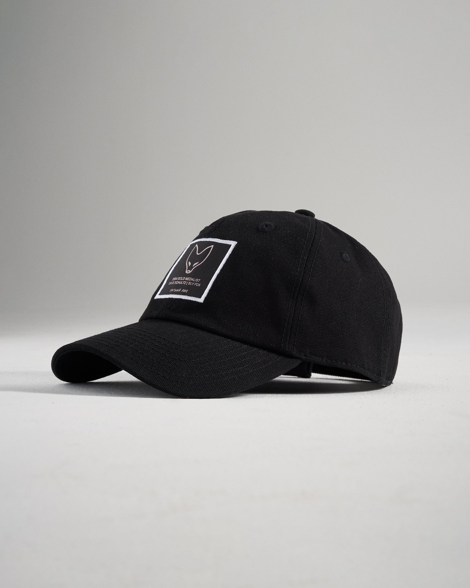 This image features a stylish black cap with a prominent logo patch designed for casual wear and aesthetic appeal