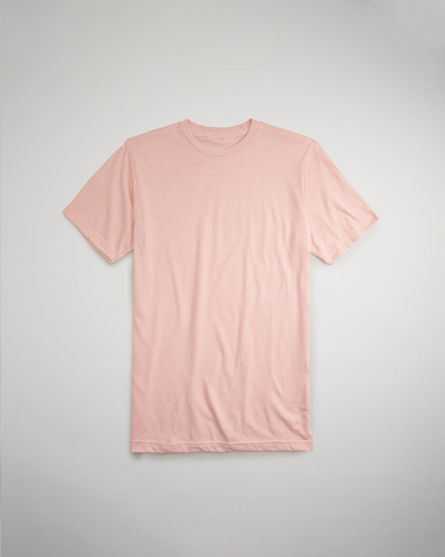 A soft pink short-sleeve t-shirt is displayed flat against a light gray background