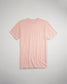 A soft pink short-sleeve t-shirt is displayed flat against a light gray background