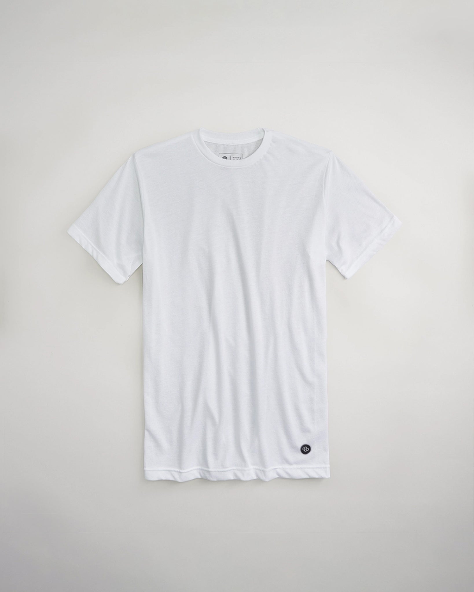 A plain white t-shirt displayed flat against a light background featuring a simple design and a small black logo at the hem