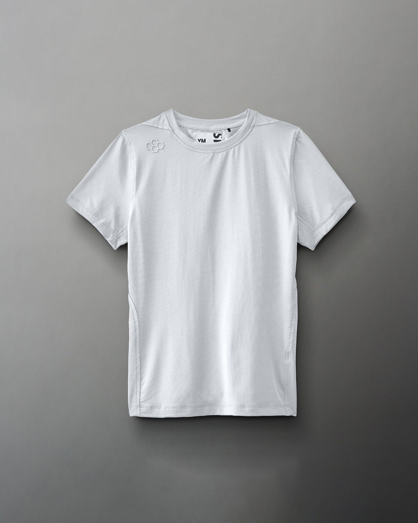 A plain white athletic shirt, minimalistically designed with a round neck and short sleeves, features a small logo on the shoulder, highlighting its lightweight and functional nature.