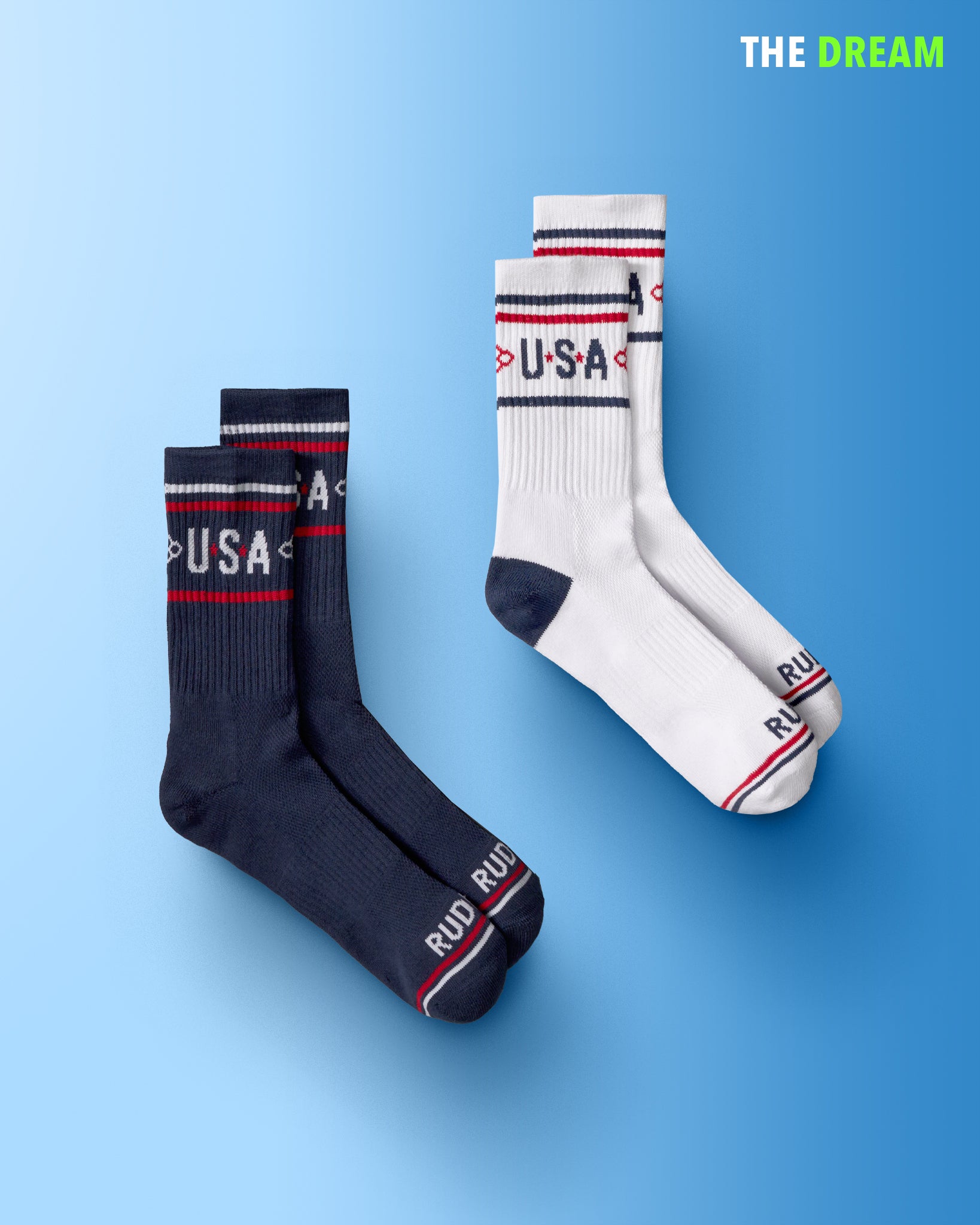 Two pairs of socks in navy blue and white, showcasing 'USA' branding and stylish stripes, are featured against a light blue gradient background.