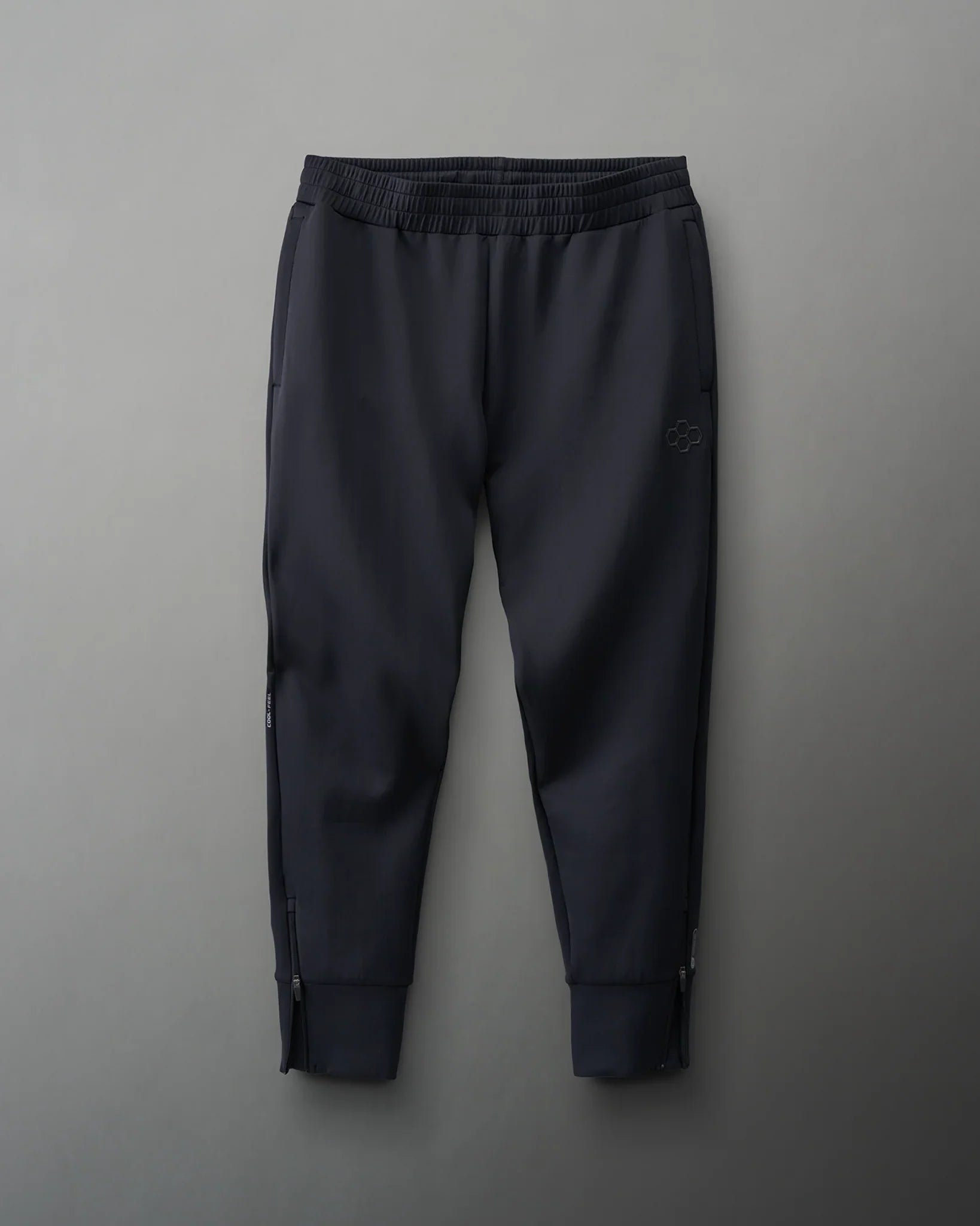 Dark athletic pants with a drawstring waist and zippered pockets, designed for comfort and practicality.