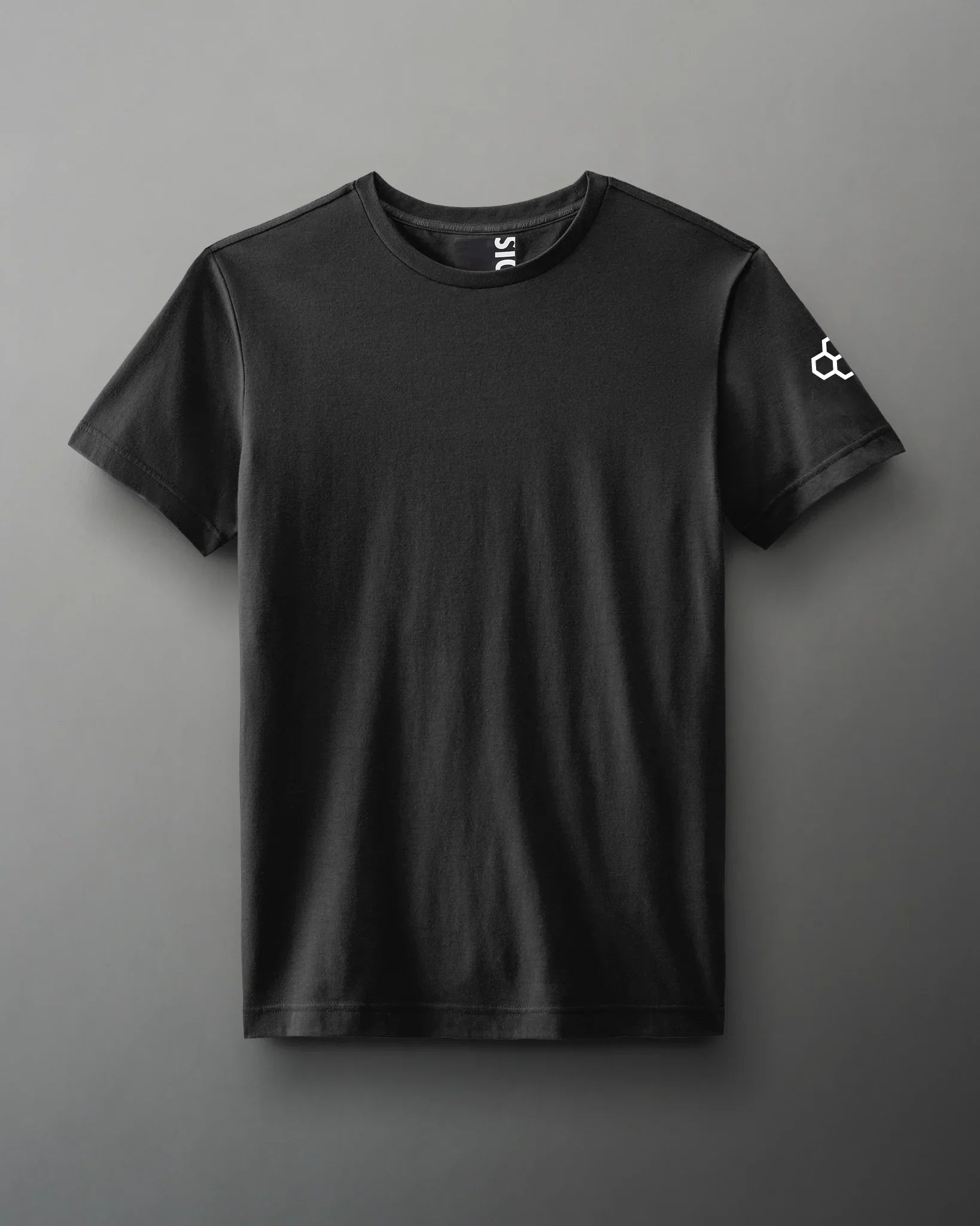 A plain black short-sleeve t-shirt with a round neckline and a small white logo on the sleeve, laid flat against a neutral gray background.