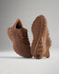 A pair of stylish brown running shoes featuring a breathable mesh upper and a textured sole designed for optimal grip and comfort