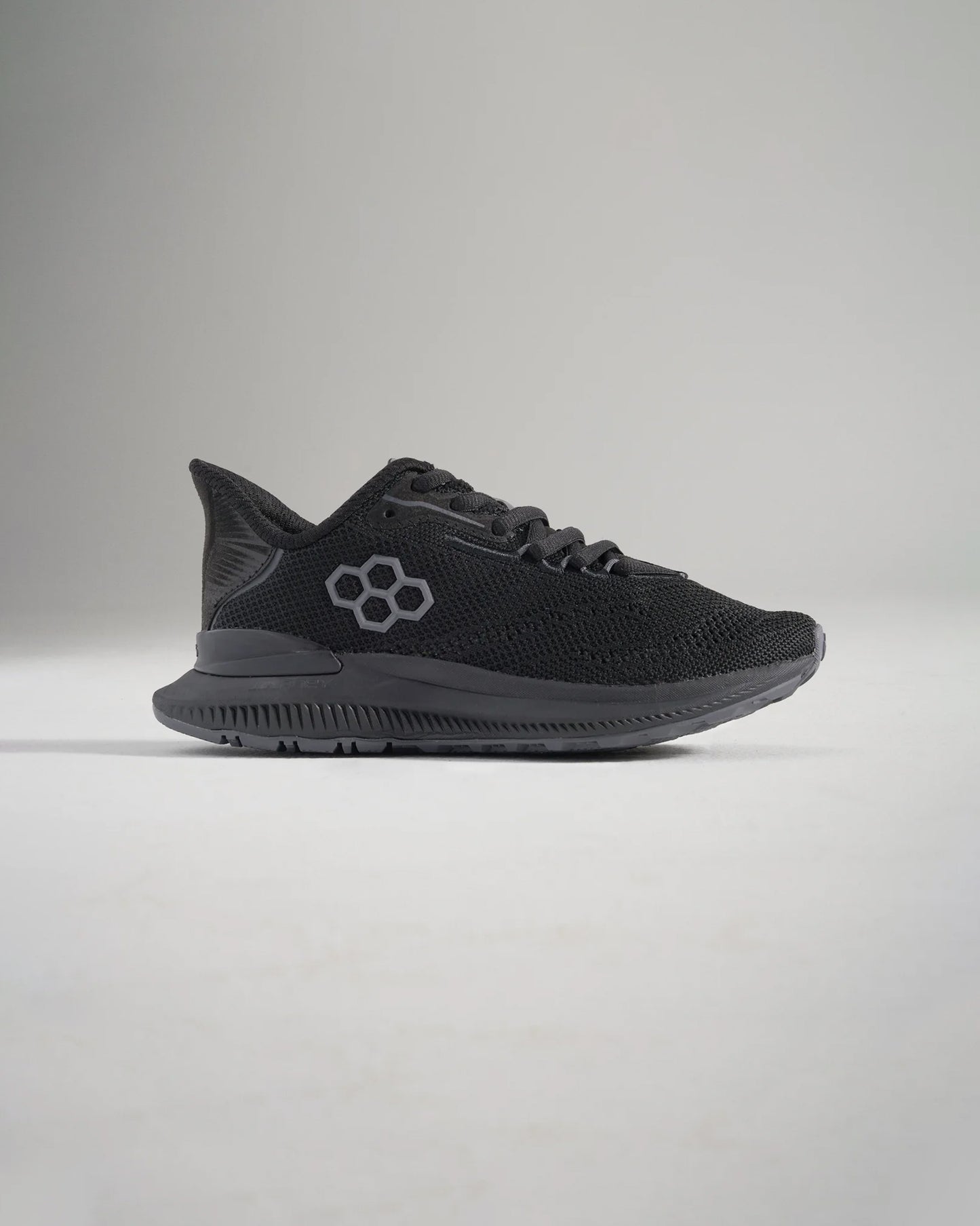 A sleek black athletic shoe featuring a breathable mesh upper stylish logo detail and a textured sole for enhanced grip and performance