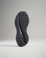 Underside view of a black athletic shoe showcasing its textured sole designed for traction and support during physical activities