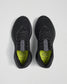 A top view of black athletic shoes featuring a breathable mesh upper and vibrant lime green insoles labeled JOURNEY