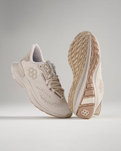 A pair of beige athletic shoes featuring a breathable mesh upper and a textured sole designed for performance and comfort