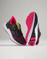 A pair of modern black running shoes with bright pink accents and a detailed textured sole designed for both style and performance