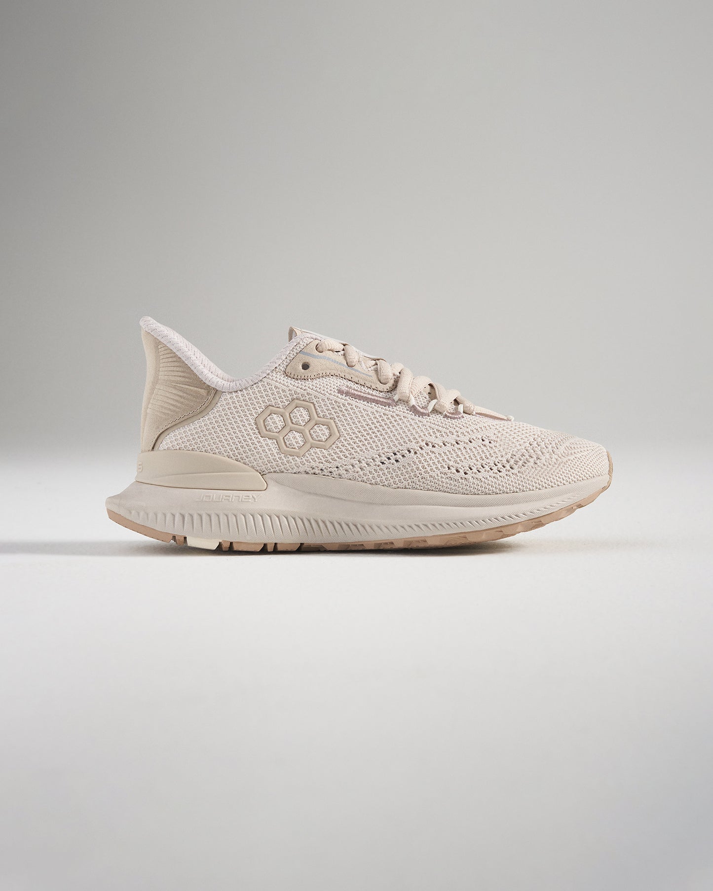 A stylish beige athletic shoe featuring a breathable mesh upper designed for both comfort and performance