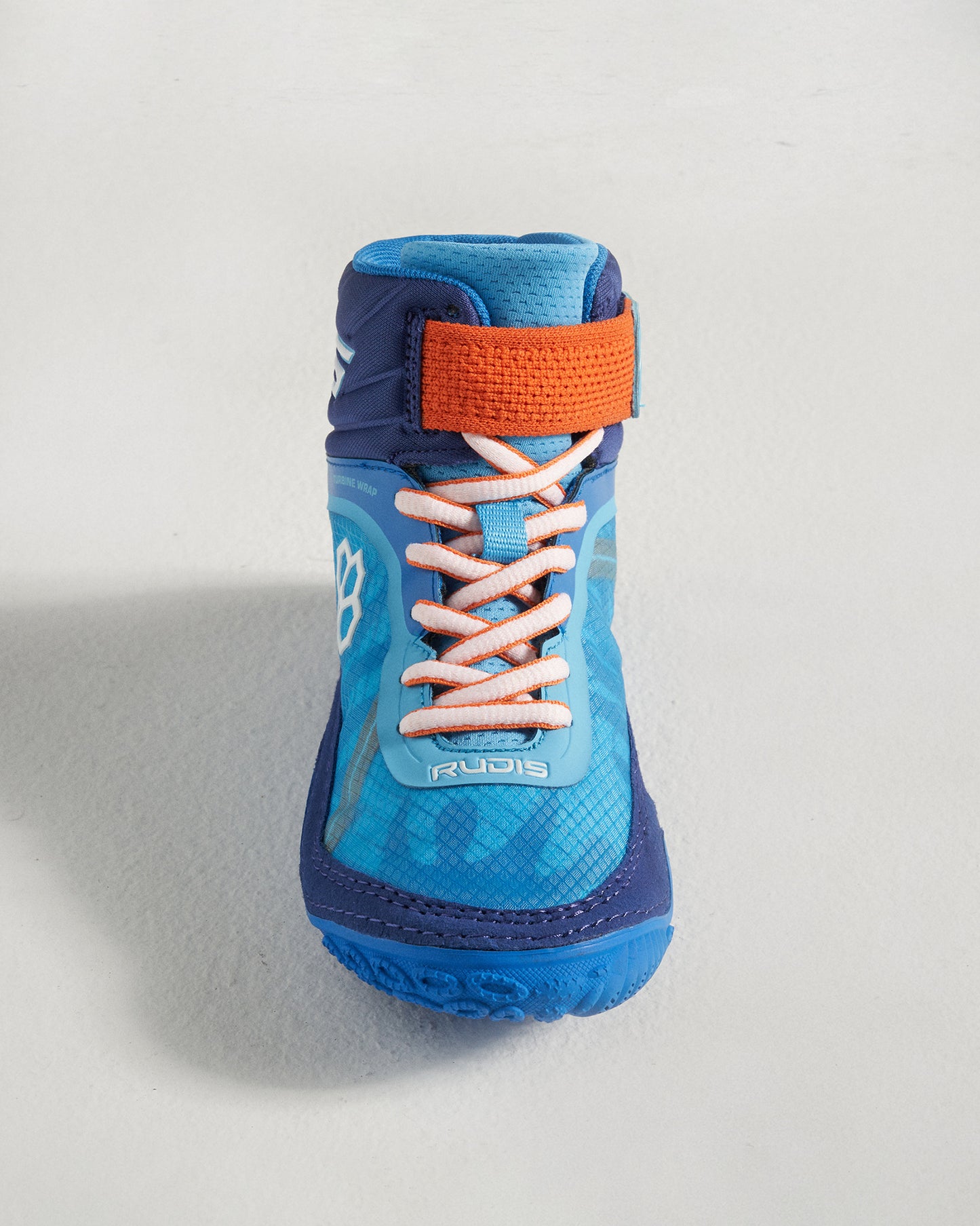 A vibrant blue wrestling shoe featuring a high-top design contrasting orange strap and laces designed for performance and stability during matches