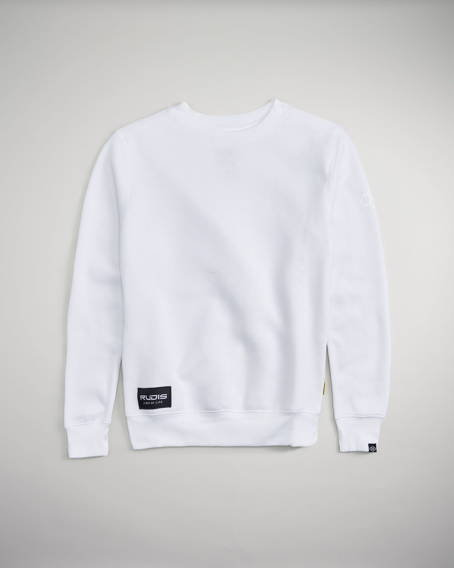 A plain white sweatshirt with a ribbed crew neck and long sleeves featuring a small brand logo at the bottom left and a label on the side