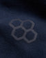 A close-up of a dark navy fabric featuring a subtle honeycomb pattern embossed on it illustrating a modern textile design