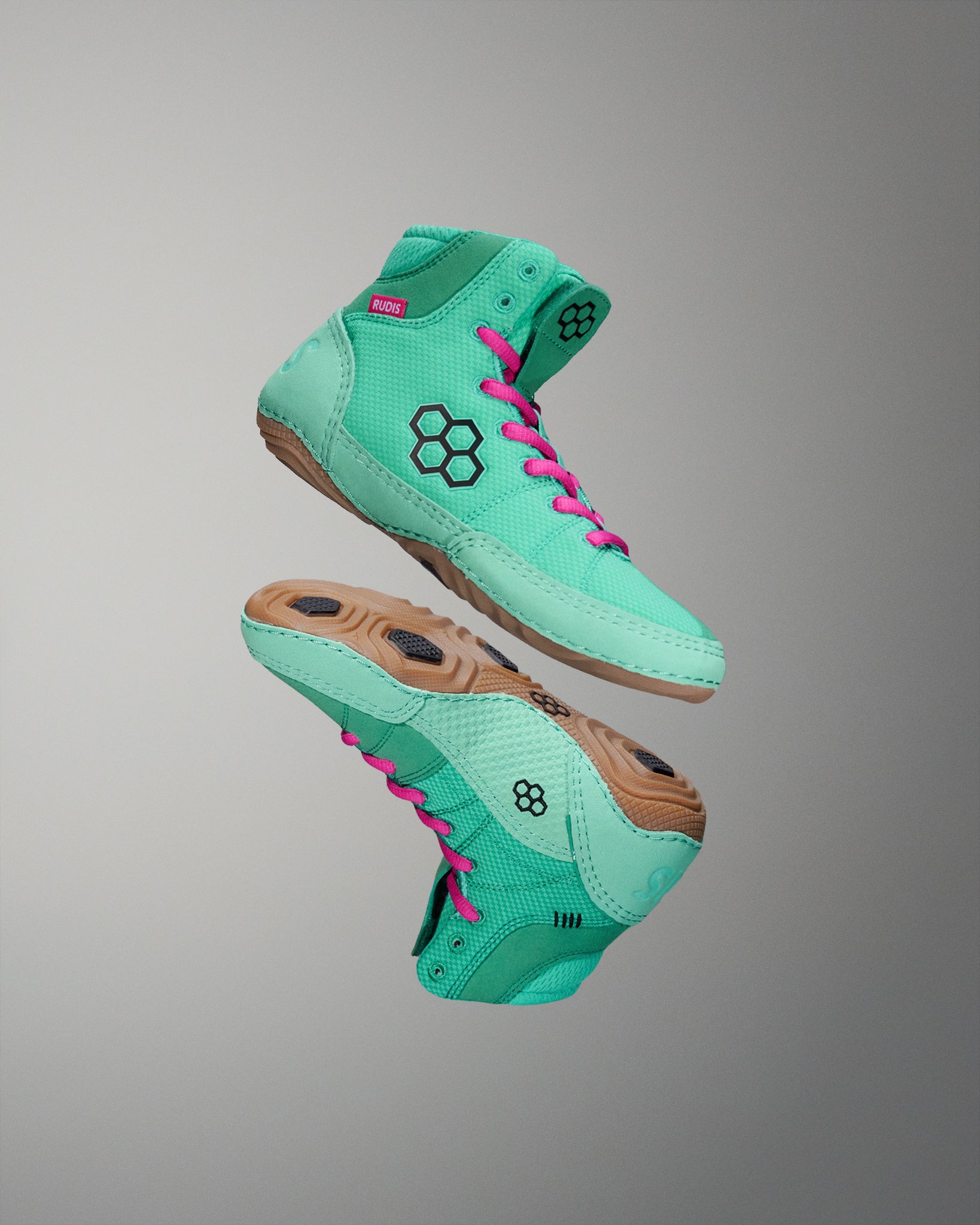 High-top athletic shoes in a vibrant mint green color with pink laces and a honeycomb logo, set against a soft gray background.