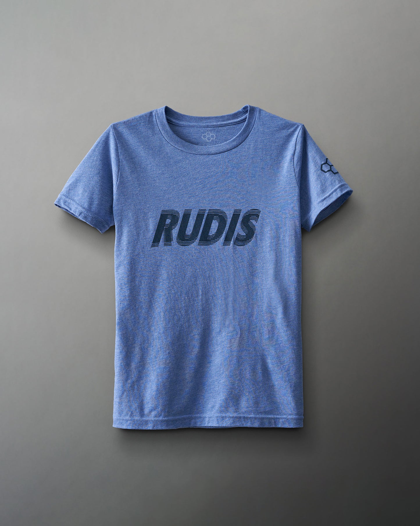 A blue t-shirt features bold black lettering spelling 'RUDIS' across the chest, highlighting its casual and athletic style against a neutral gray background.