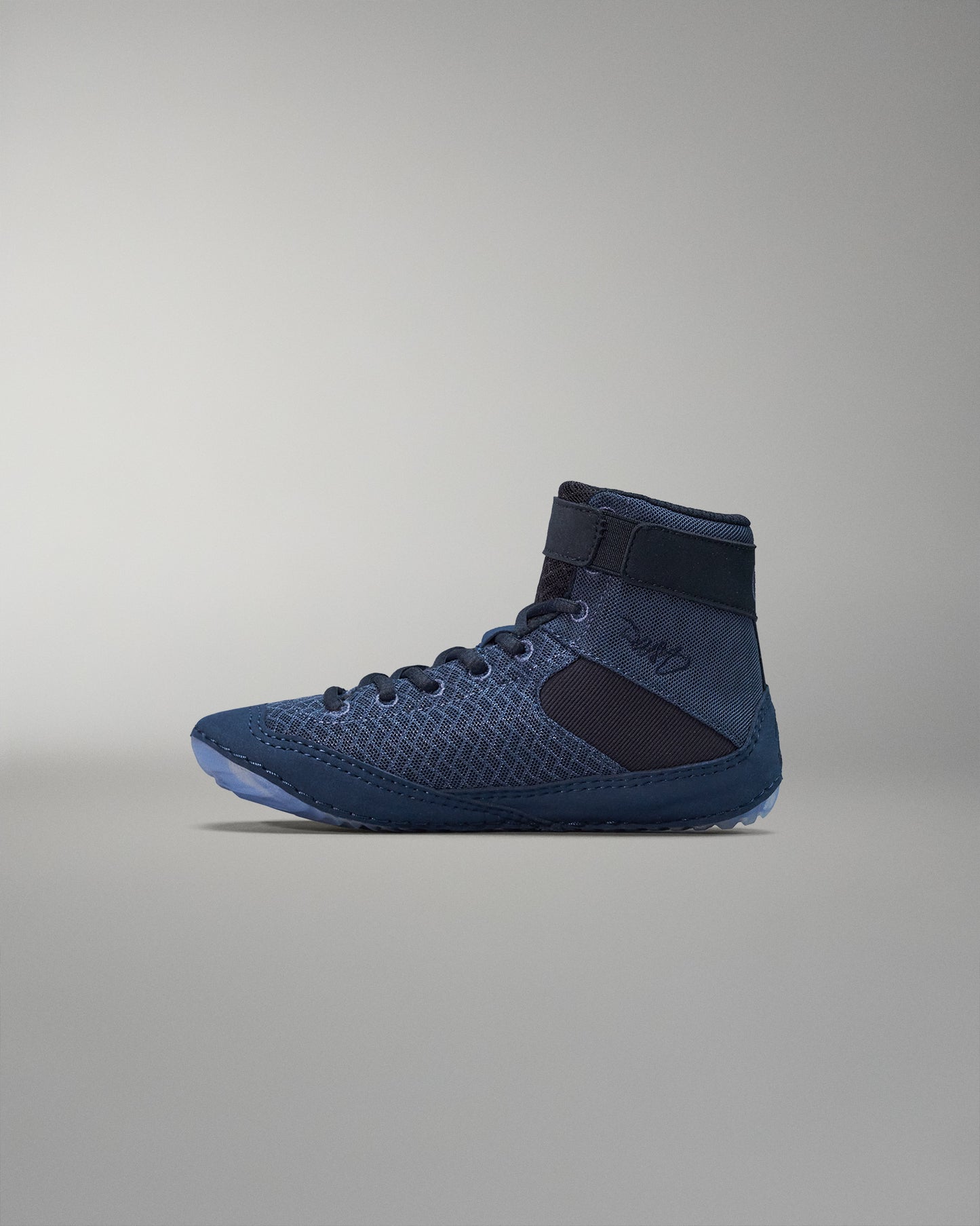 High-top athletic shoe in dark blue with a textured mesh upper, black accents, padded collar, and a velcro strap for a secure fit.