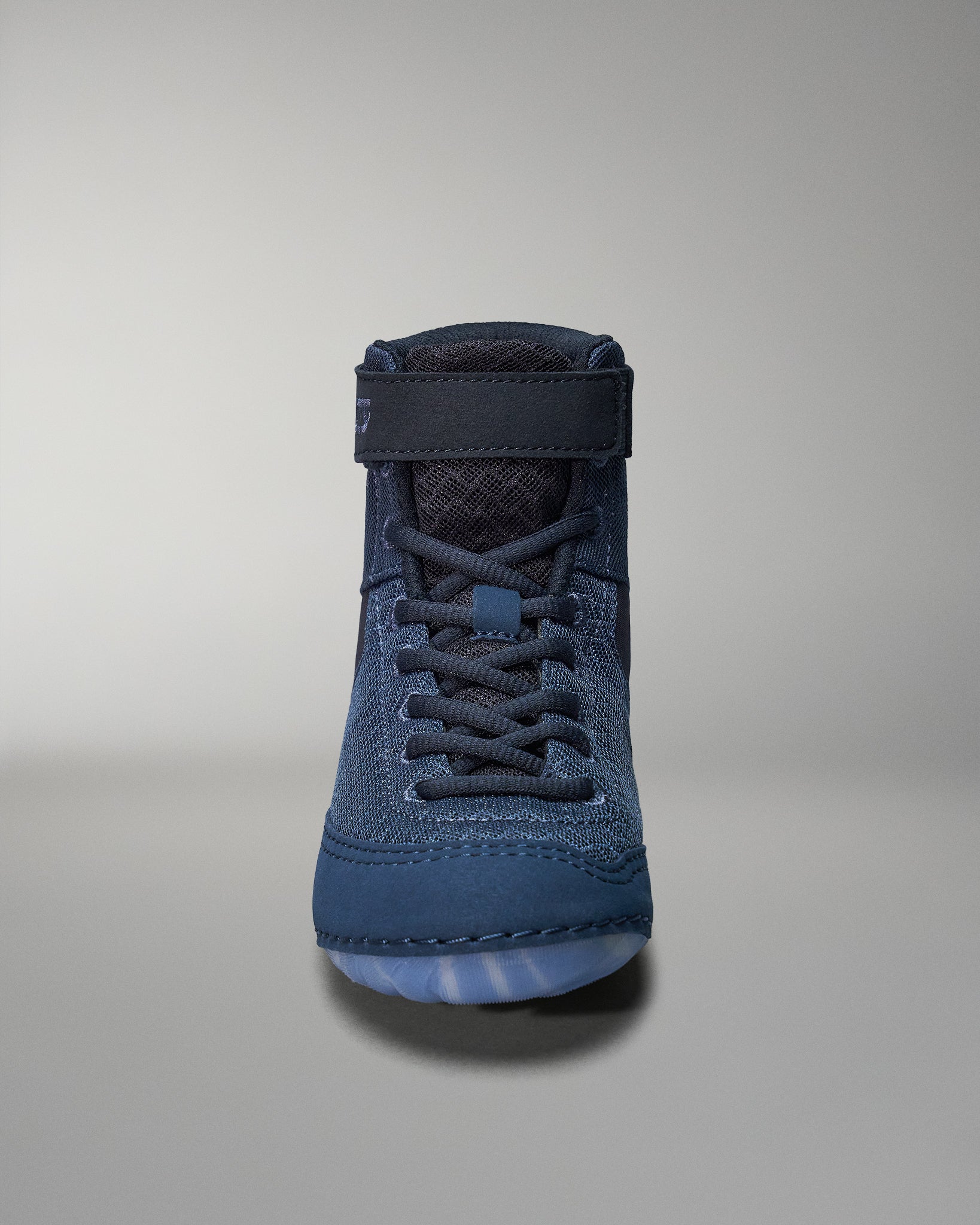 A high-top shoe with a dark blue fabric upper, reinforced stitching, and a textured rubber sole for traction.