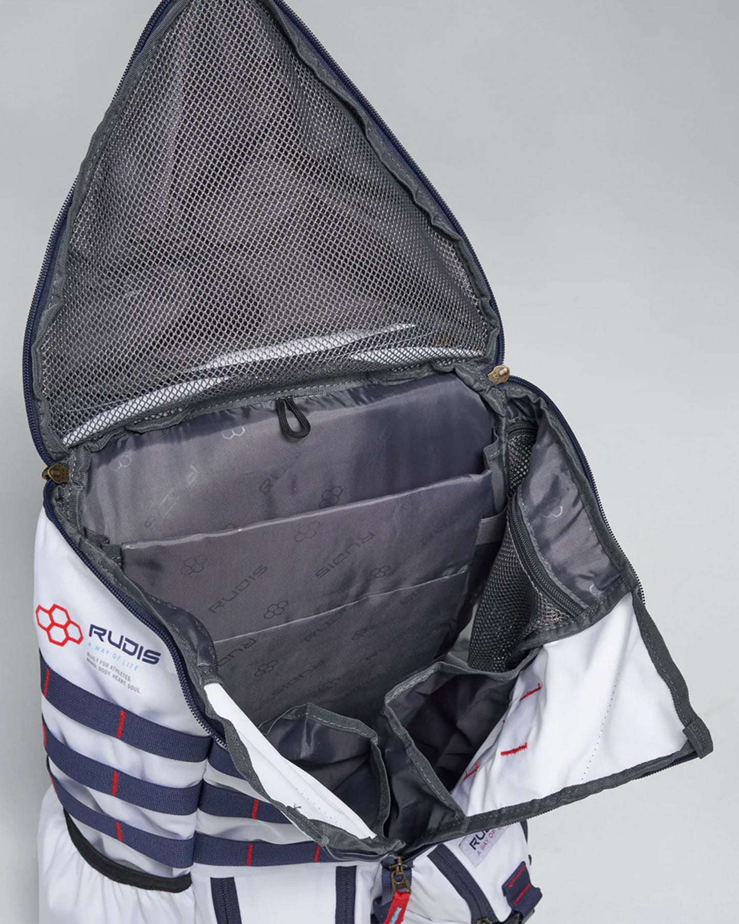 An open white and navy blue duffel bag showcasing multiple compartments and a mesh pocket designed for efficient organization and travel comfort