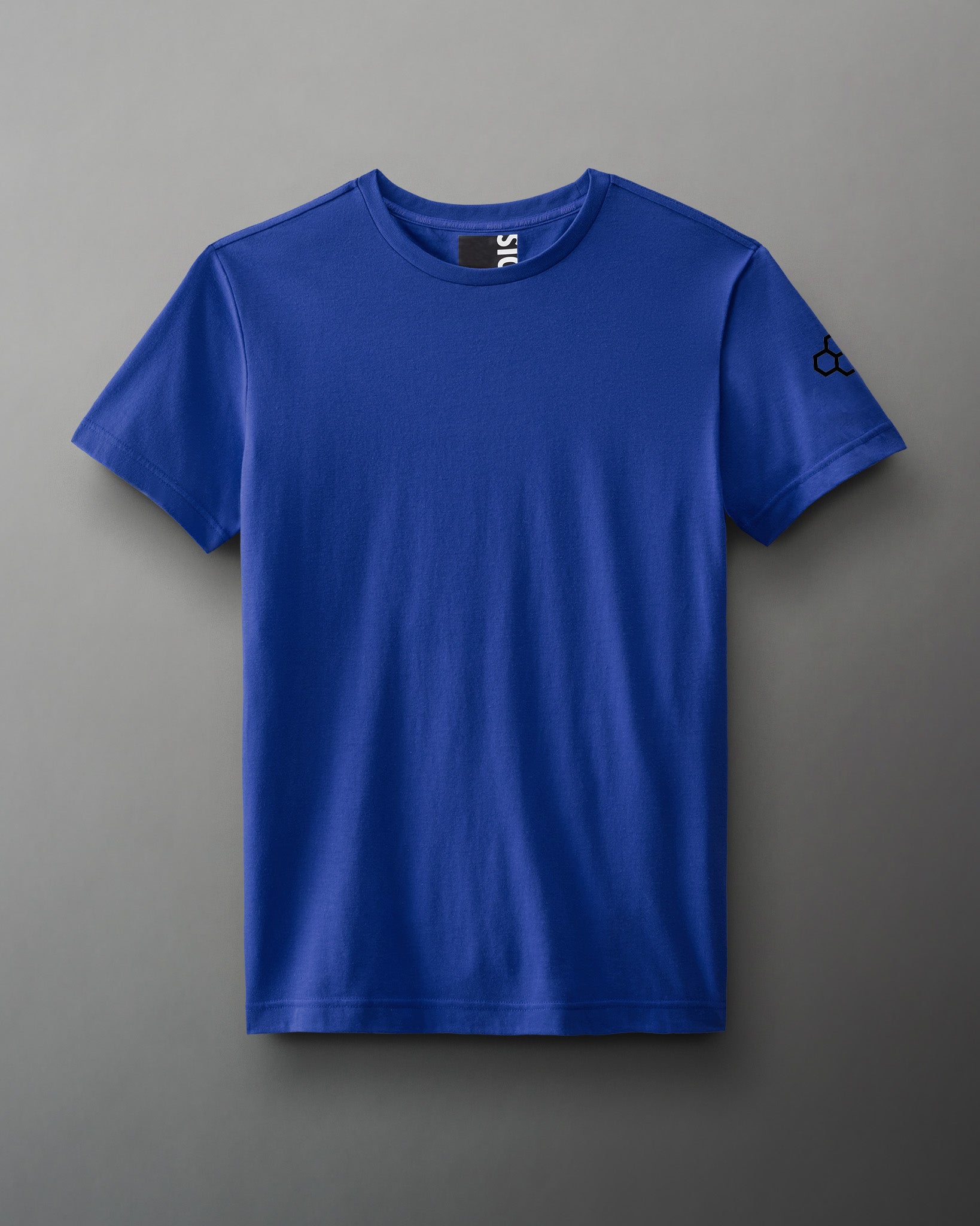 A blue short-sleeve t-shirt with a classic neckline and a small black logo on the sleeve is displayed against a soft gray background.