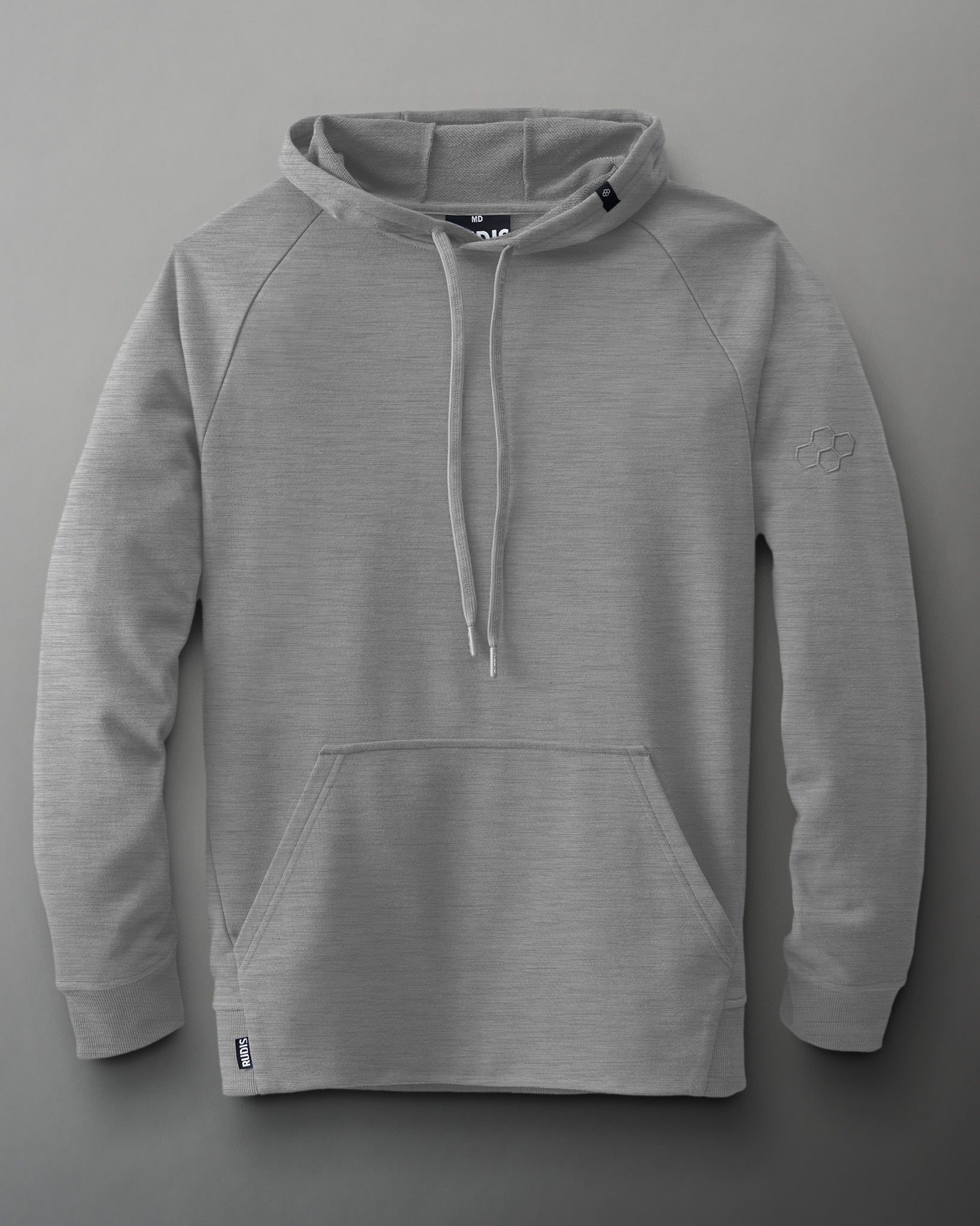 A gray hoodie with a kangaroo pocket and drawstrings, displaying a relaxed fit and embossed logo on the left sleeve against a simple gray background.