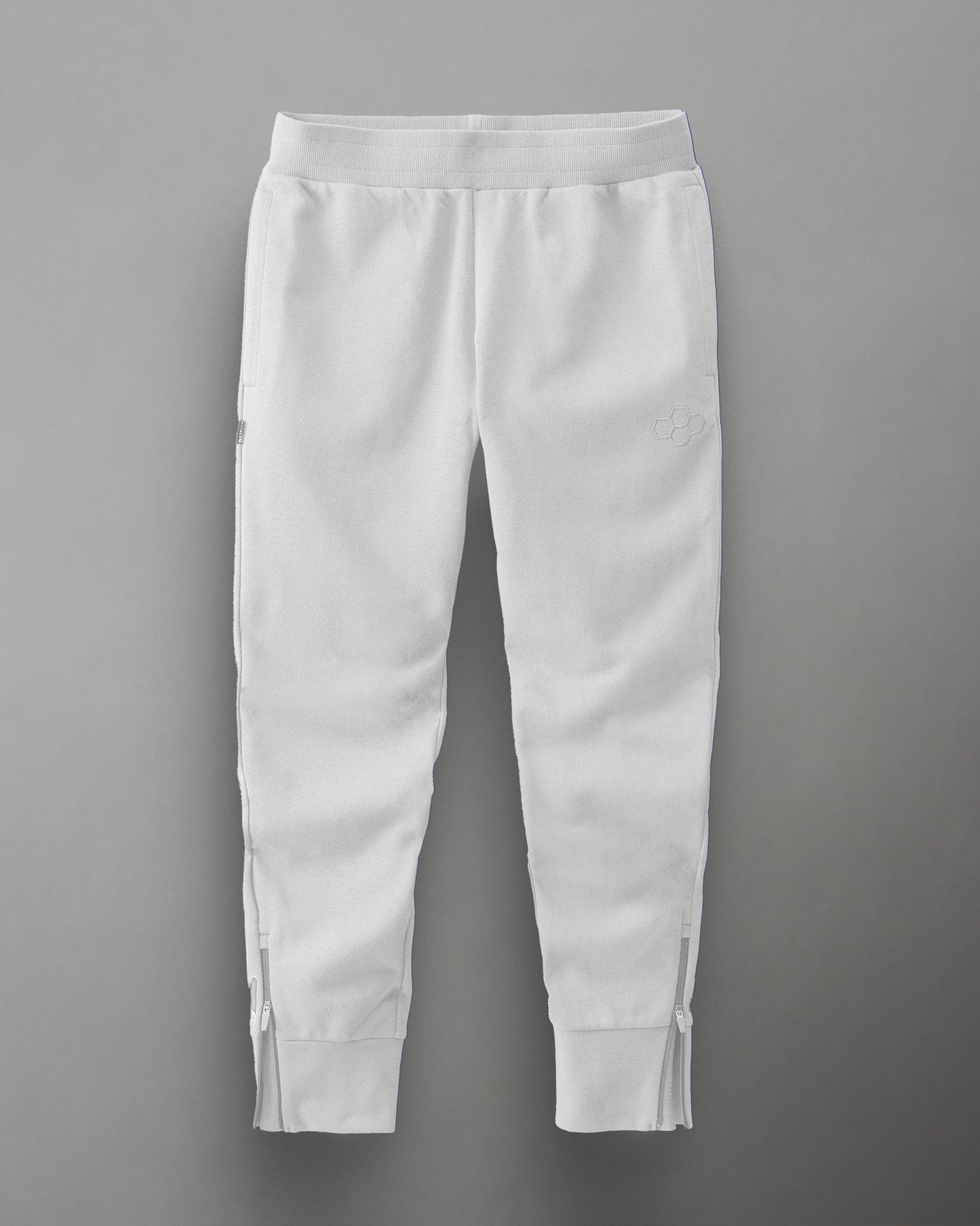 White athletic sweatpants with adjustable zippers at the ankles and an embroidered logo, designed for comfort and style in sports or casual wear.